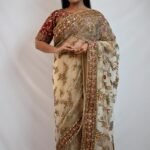 Elegant Cream Net Saree with Maroon Floral Embroidered Red Blouse & Zari Border